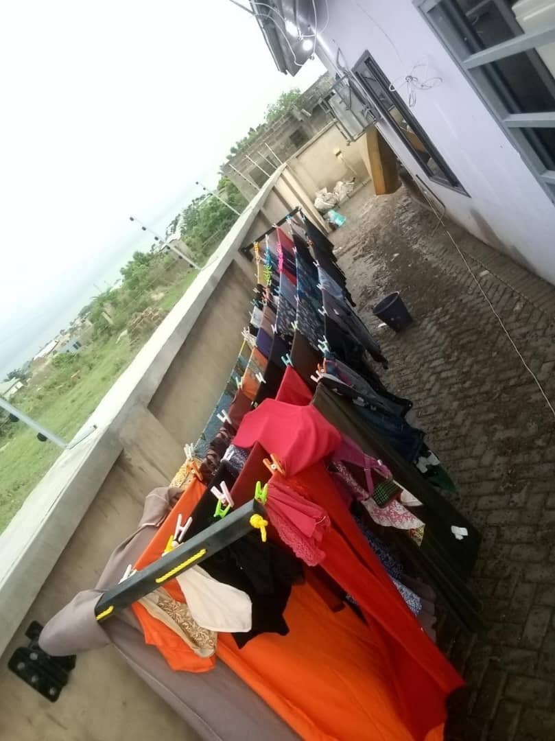 Foldable drying line holding a full load of washing, clothes spread across every line