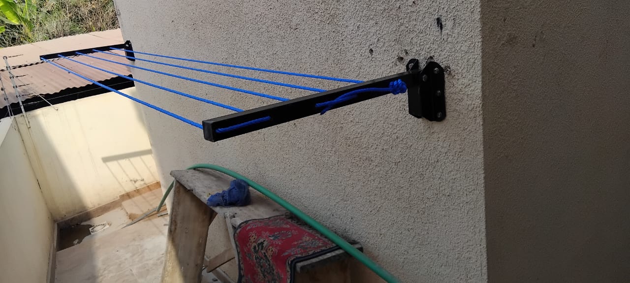 Foldable drying line with blue lines fitted above a laundry area