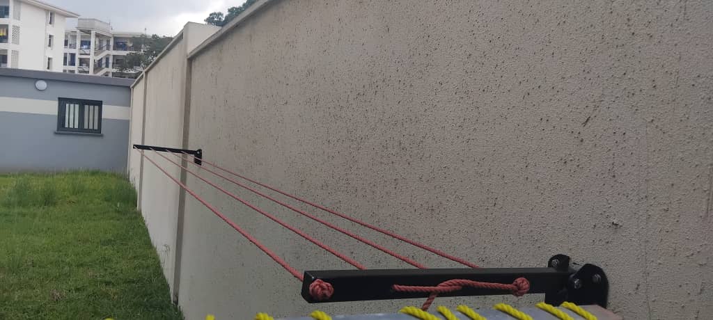 Foldable drying line with red lines mounted on a garden boundary wall